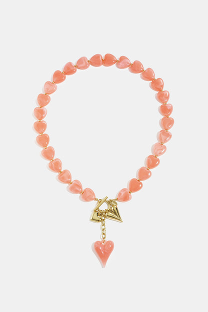 Bead necklace with hanging heart charms