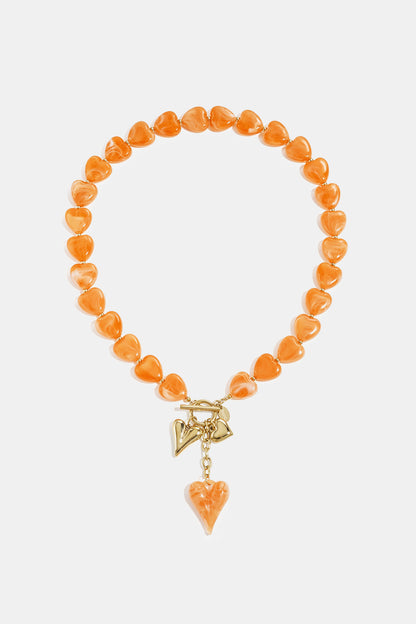 Bead necklace with hanging heart charms